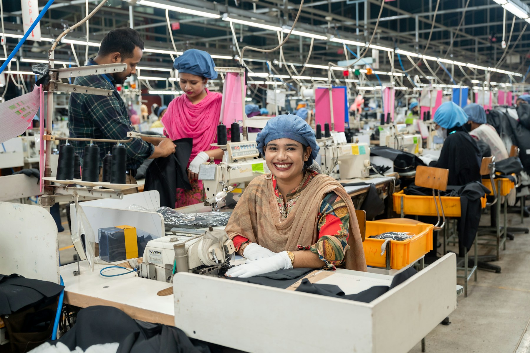 Illustrative garment factory production floor with sewing teams