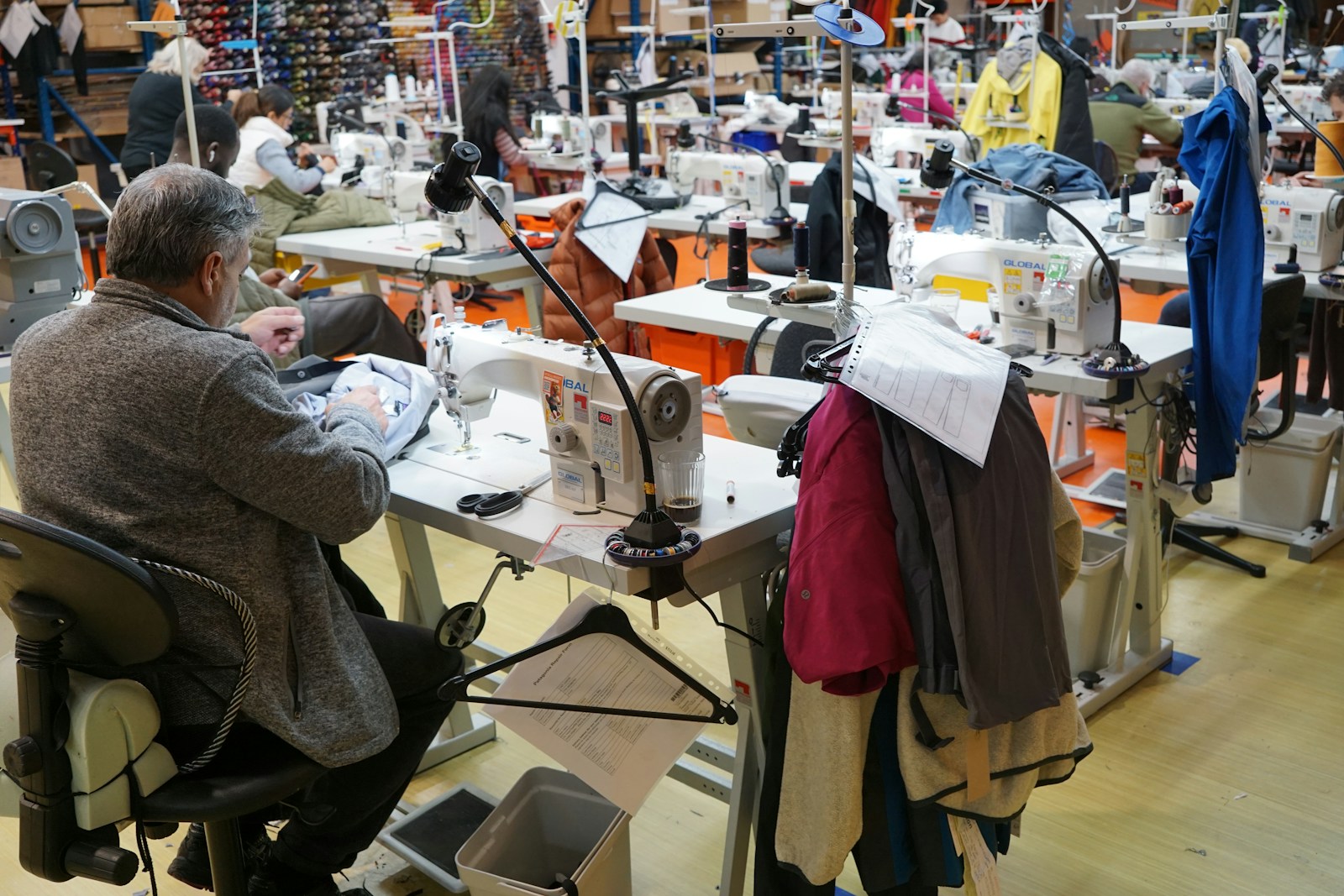 Illustrative tailor working on garment construction